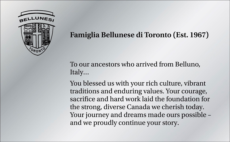 Shiny silver plaque with a crest and text.