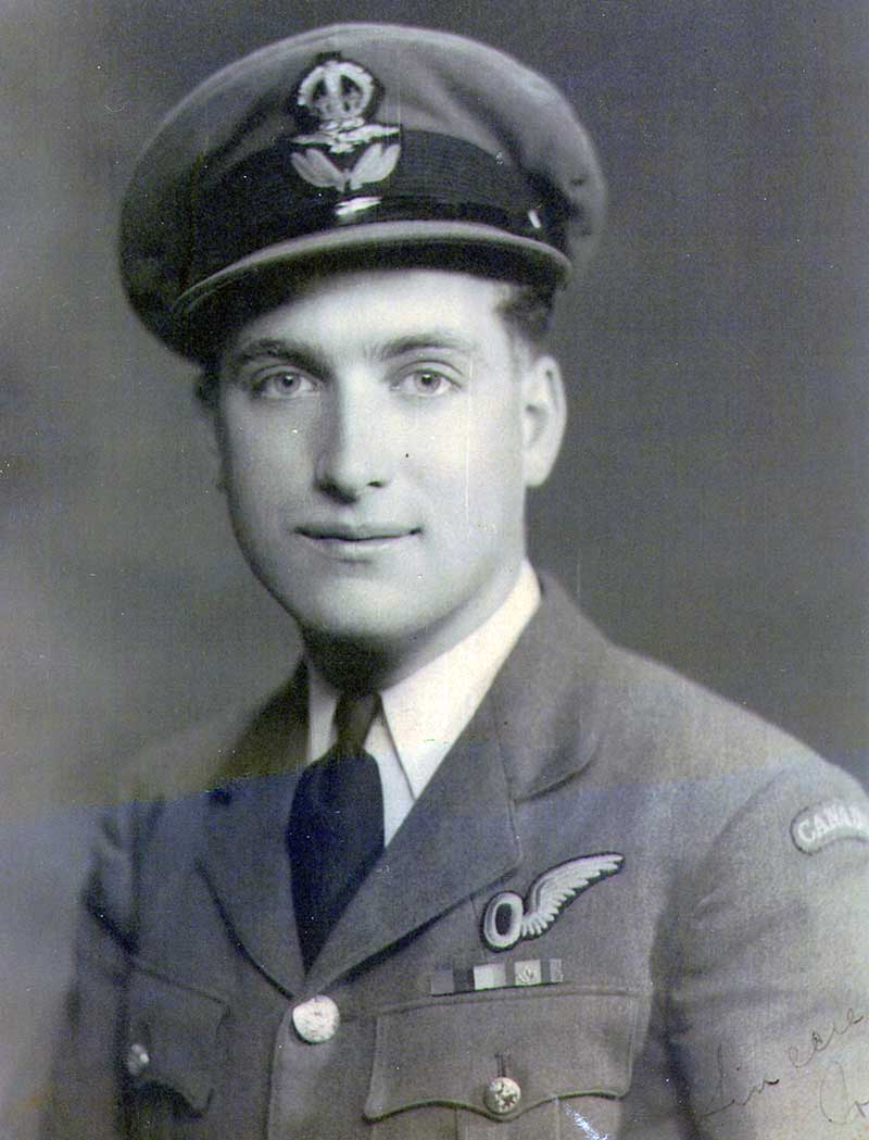 A young man sitting with back straight and looking into the camera