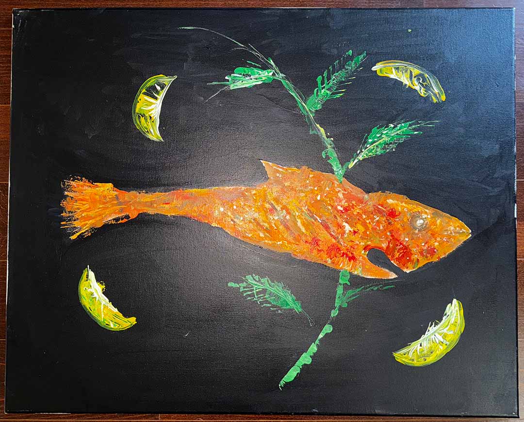 Fish with garnish and four lemon wedges on a black background.