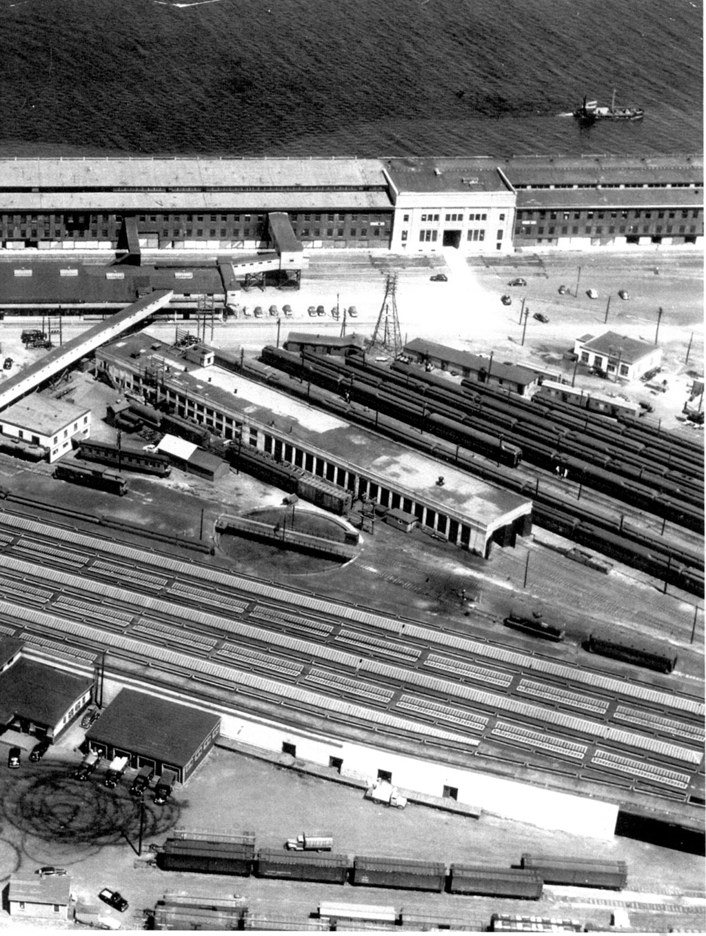 An aerial but blurry view of train tracks leading to a body of water.