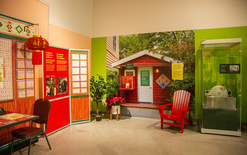 A wall of exhibition panels, including a model restaurant and information about Indigenous food history.