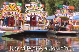 Colourful boats can be seen on a body of water.