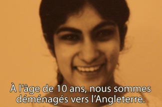 A young woman smiles and looks at the camera.