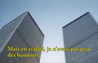 The tops of two very tall buildings can be seen from below.