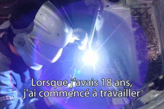 A bright arc of light is seen as someone is welding.