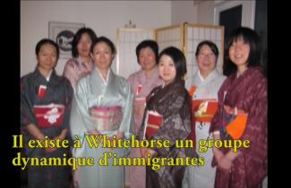 A group of pretty young women dressed in kimonos.