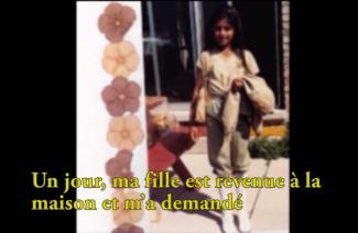 A pretty young girl stands and poses for the camera.