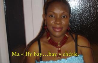 A young girl with colourful clothing on, smiles at the camera.