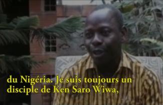 A young man in a striped shirt is talking to someone off camera.