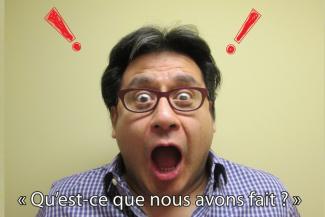 A man has a shocked face with two animated exclamation marks on either side.