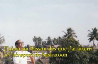 A smiling man in sunglasses looks up at the sky.