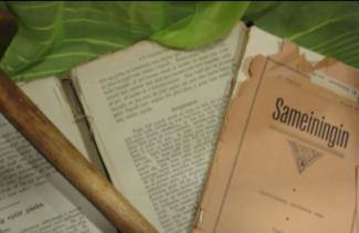 A very old book pulled apart into three sections.