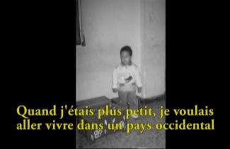 A black and white image of a small little boy.