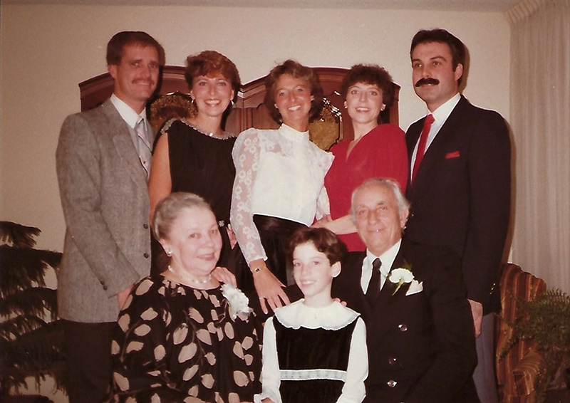 A well-dressed family have their photo taken.