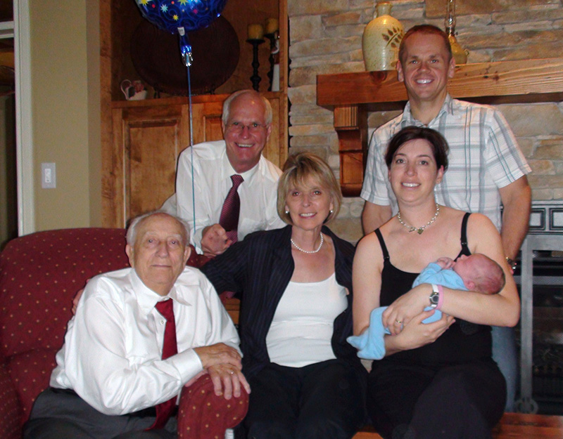 Adults and a small child pose for a photograph.