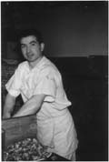 Young António in white cook's outfit.