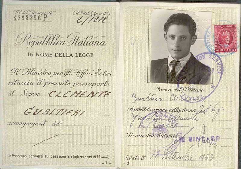 Faded Italian passport, opened to photo page.