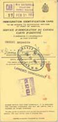 Yellow document reading Immigration Identification Card.