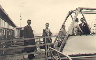 Family as seen from dock, walking on the gangplank to ship.