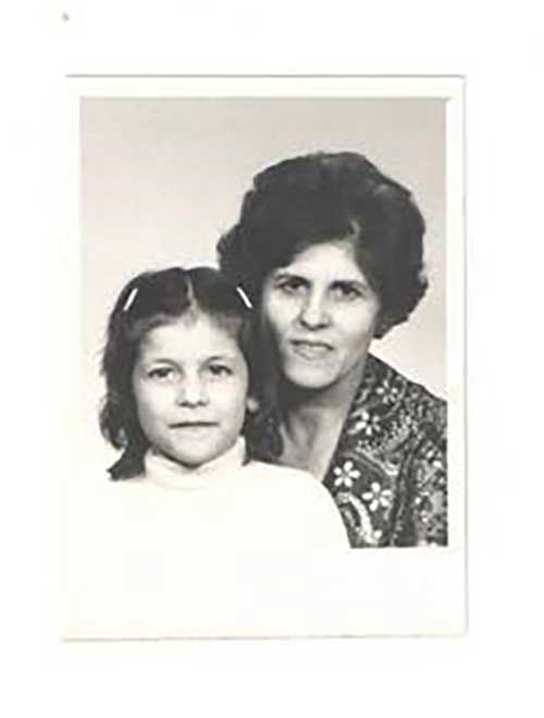 A woman and young girl pose for the camera.