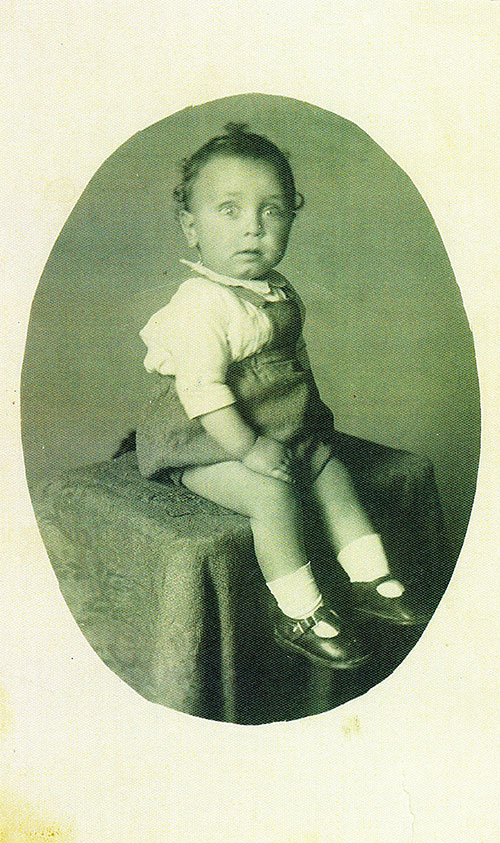 Cute baby siting on a table for photo.