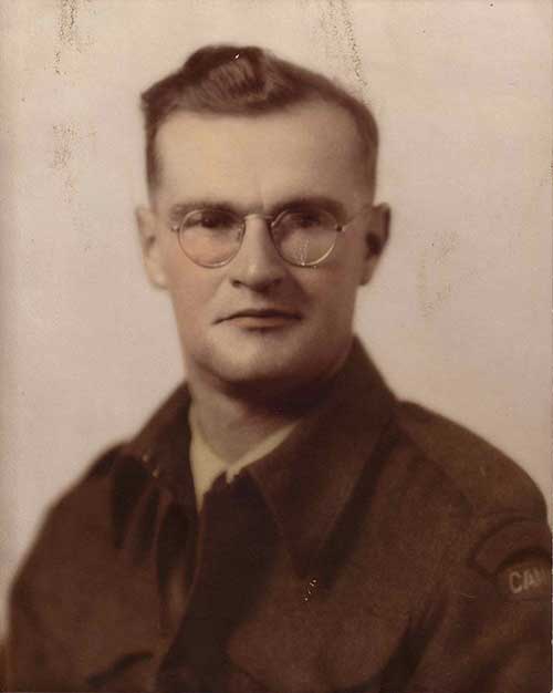 Headshot photo of young man with glasses.