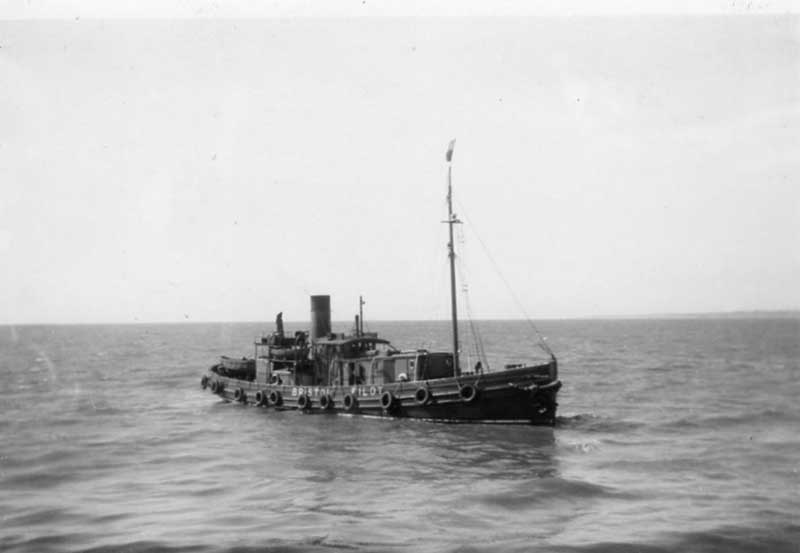 A small ship sails in the sea.