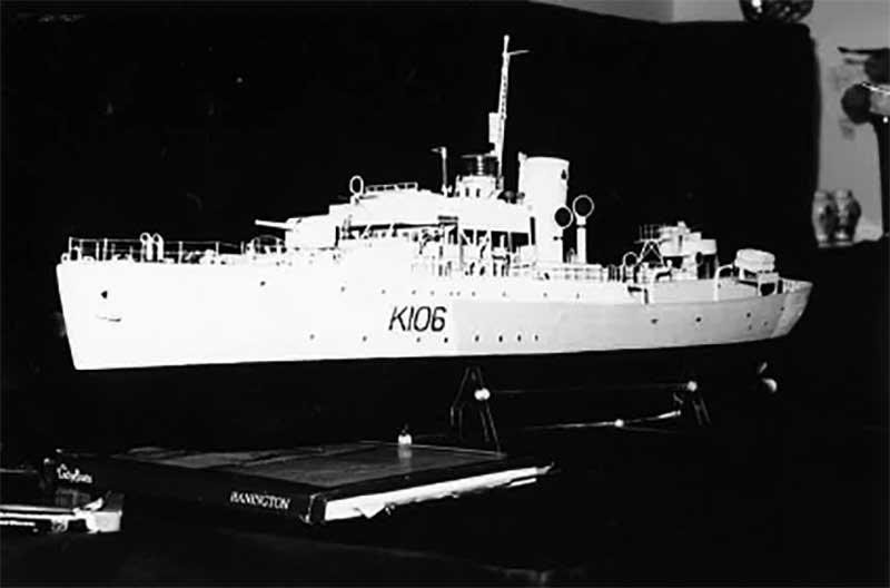 A model of a ship sits on a desk, K109 is written on it.