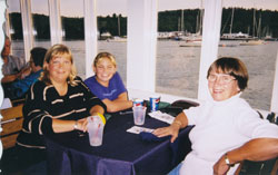 Irene, Fiona and Sarah sitting at a restaurant table with a purple tablecloth.