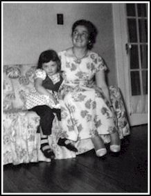 Woman and girl sitting on a couch.