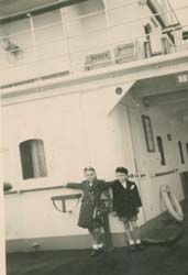 Two small children on deck of ship.