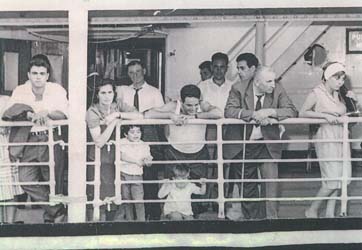 Several adults and children on deck of the Vulcania.