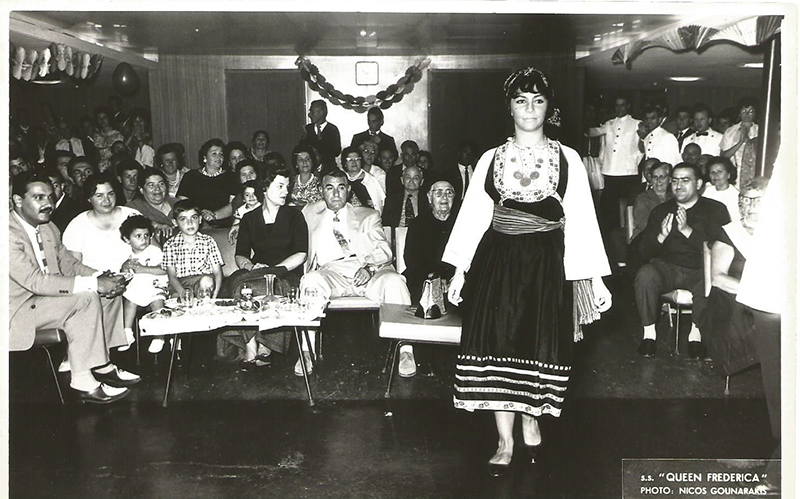A large group of people are sitting and watching a show.
