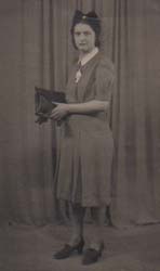 A well-dressed woman is standing for a photo.