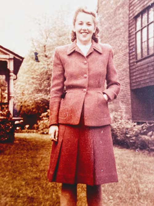 A well-dressed young woman poses for a photo.