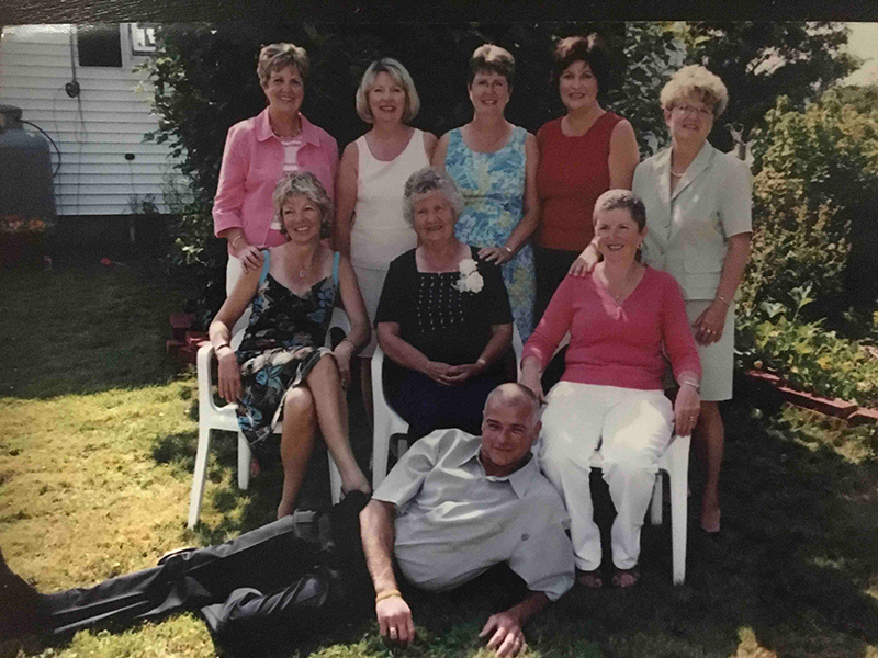 Family members spread out on the front lawn of their house.