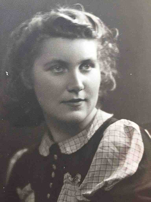 Old portrait of a young woman looking off in the distance.