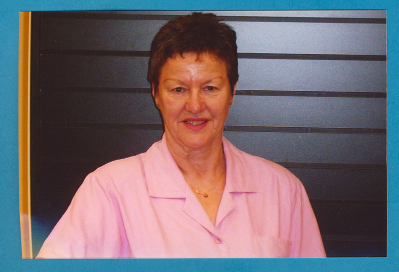 Older woman in pink shirt.