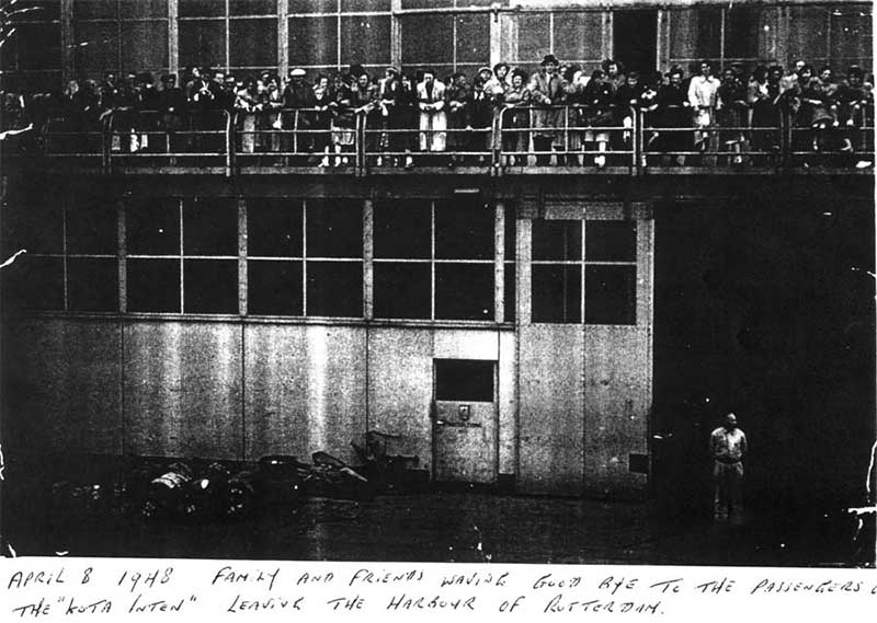 Group of people are standing on a dock.