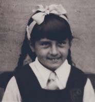 Young girl with big white bow in hair.