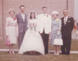Bride and groom with parents on either side.