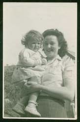 Recent color photograph of the elderly Wilson and their granddaughter, taken outside.