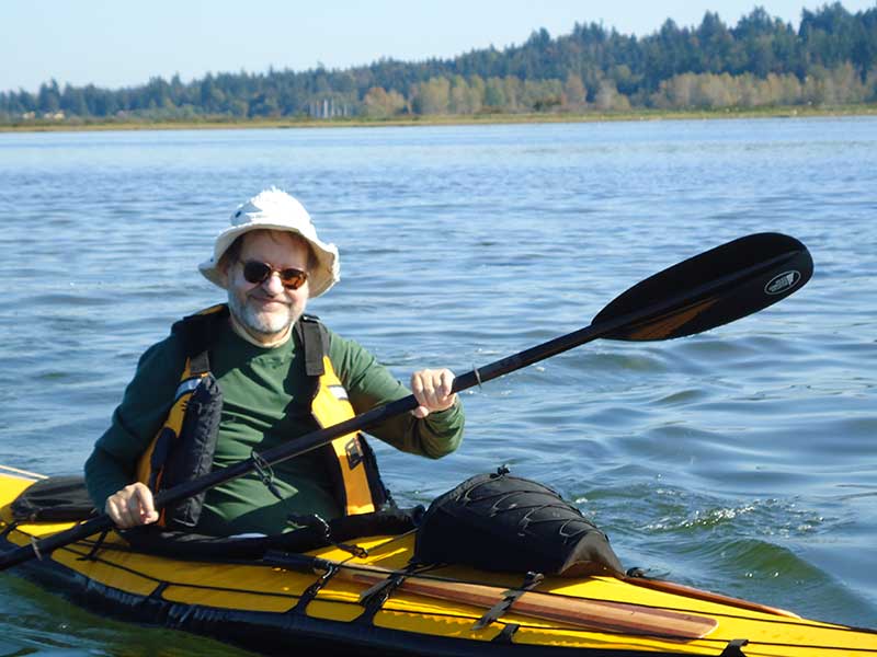 Man kayaking on a sunny day.