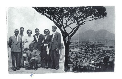 A group pf people on left side of photo and view of a hilltop on the right.