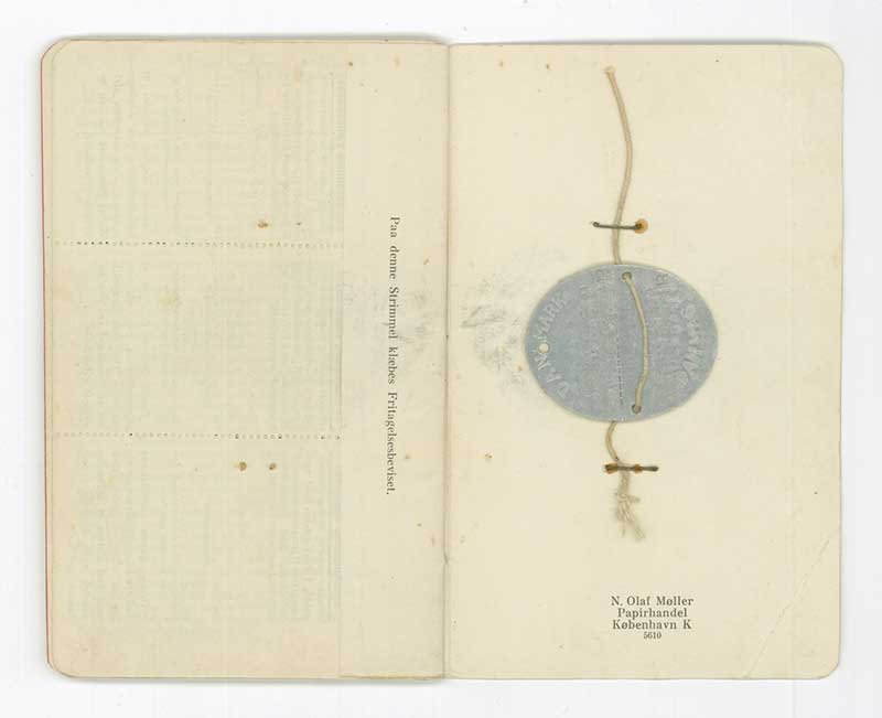 Military book pages with staple silver medal.