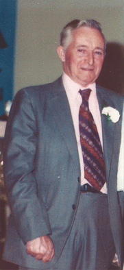 Head and shoulders photo of Cecil, wearing watch and holding cigarette.
