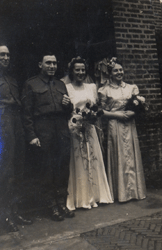 Bride and groom on their wedding day with their witnesses present.