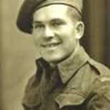 Black and white portrait of young male soldier wearing uniform and a beret.