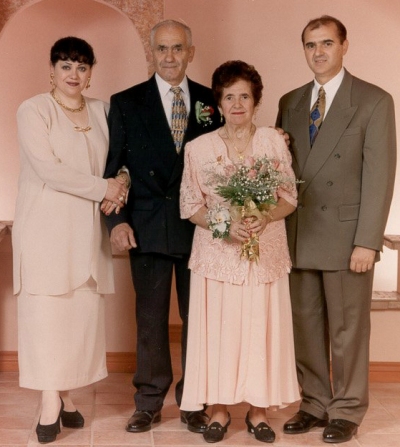 Coloured family portrait of Luigi and sister as adults, with their parents between them.