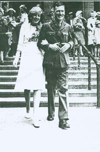 Newlyweds, walking down church steps on the day of the wedding.
